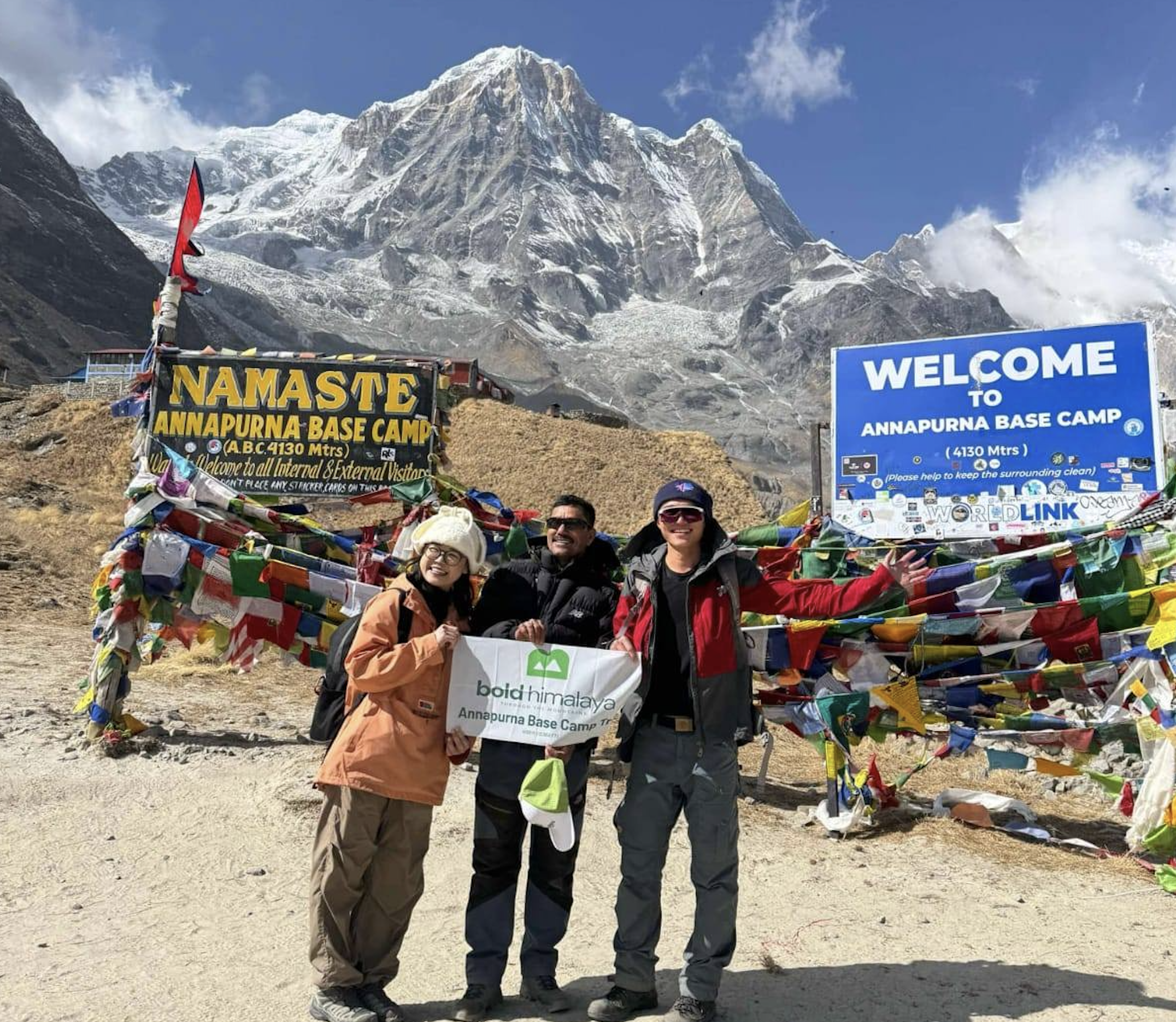 Bold Himalaya Team celebrating at Annapurna Base Camp (4,130 m / 13,549 ft) surrounded by stunning Himalayan peaks during Annapurna Base Camp Trek