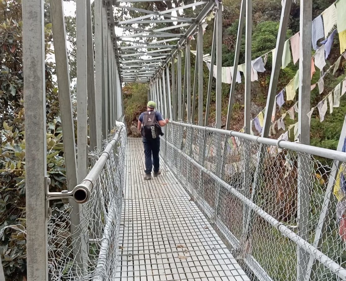 Crossing mountain river in Lantang Valley Trek