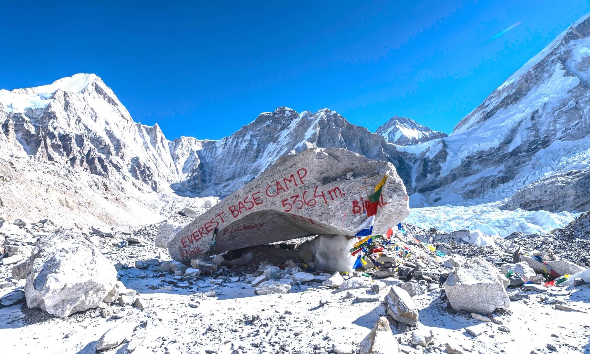 Everest Base Camp 5364m stone marker with Himalayan mountains during Everest Base Camp Trek with Island Peak Climbing in Nepal.