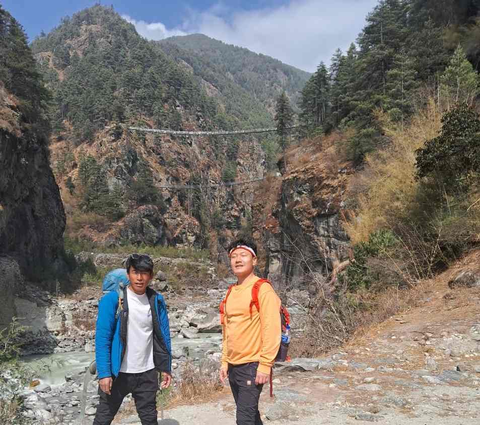 Trekkers standing in front of Hillary Suspension Bridge on the Everest View Trek route toward Namche Bazaar.