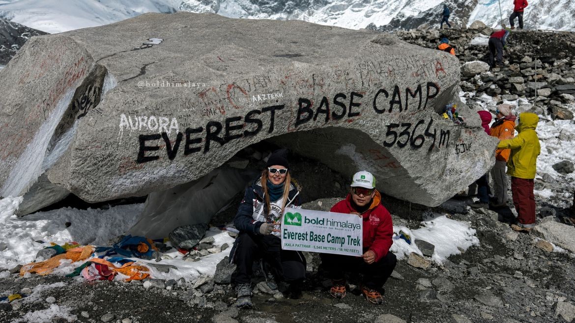 Trekkers holding their Everest Base Camp 11 days trek banner at Everest Base Camp.