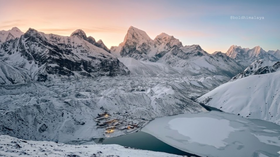 Sunset view with the icy surface of Gokyo Lake, during Gokyo Lake Trek