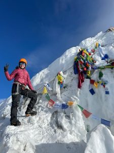 mountaineer traversing a glacier during the Island Peak climb, surrounded by pristine snowfields.