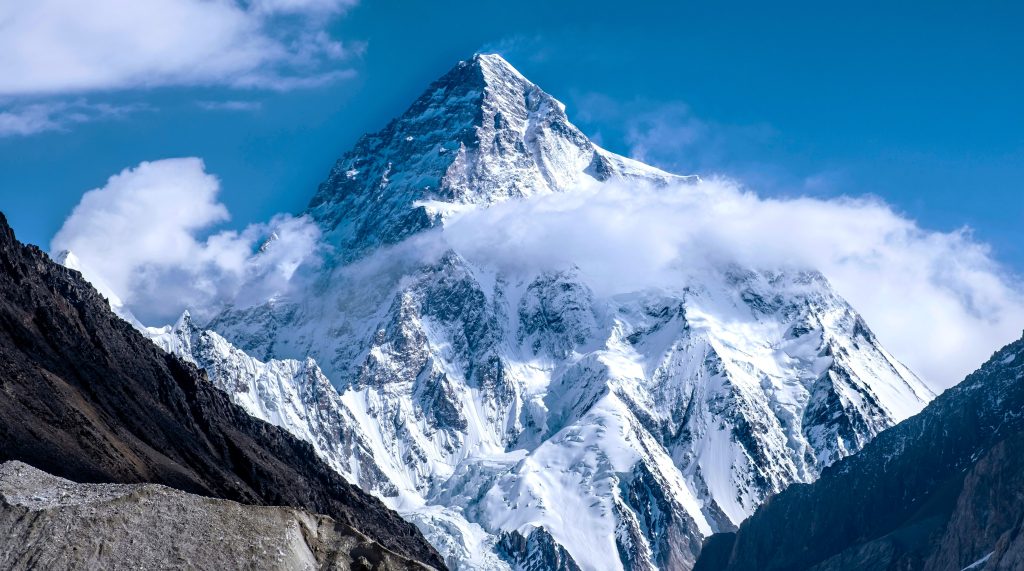 K2 mountain rising sharply above the Karakoram range, one of the 14 highest mountains in the world, covered in snow and ice
