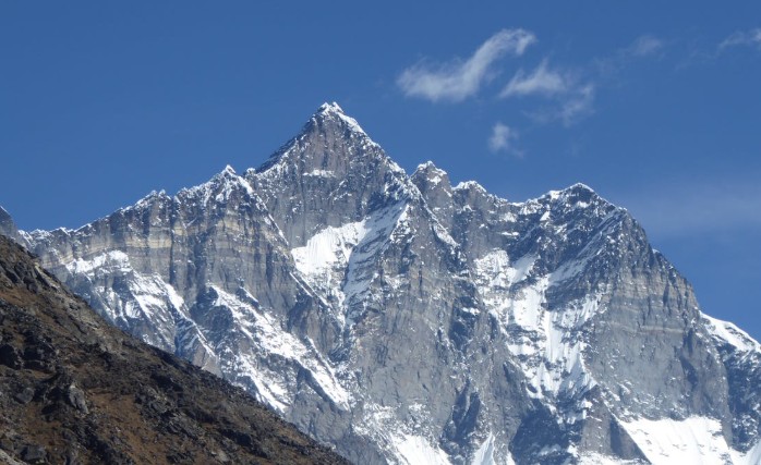 Mount Lhotse, rising beside Mount Everest in the Himalayas, one of the 14 highest mountains in the world, featuring steep icy walls and a towering snow-covered summit