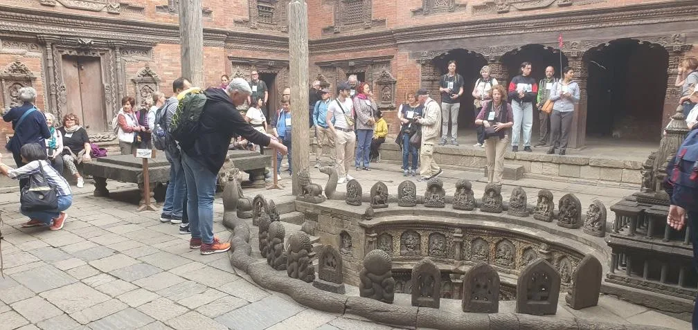 Tourists exploring Patan Durbar Square’s ancient temples and stone carvings during the Kathmandu Valley sightseeing tour in Nepal