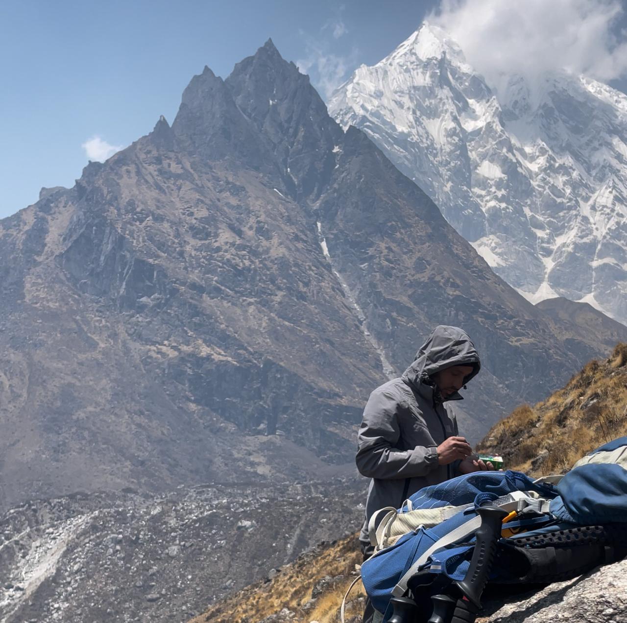 Trekker resting while climbing Langtang Valley Trek Nepal Himalayas