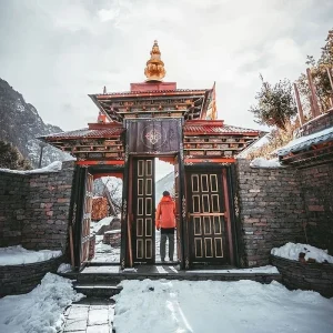Trekkers standing at the tea house gate in Namrung Village during the Manaslu Circuit Trek in Nepal