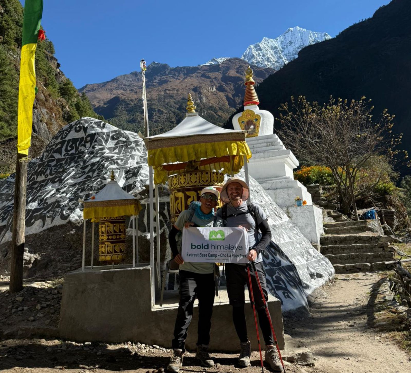 Trekkers walking past Buddhist stone carvings with mantras on the Everest Base Camp or Manaslu Trek-Manaslu Circuit Trek Larke La Pass