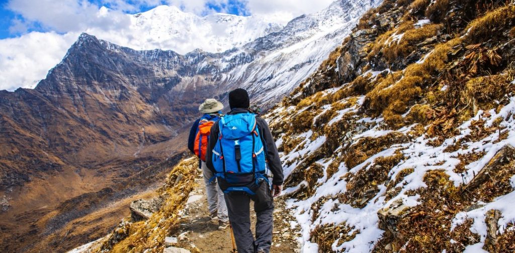 Trekking in the Himalayas through lush green forests and mountain valleys in Nepal
