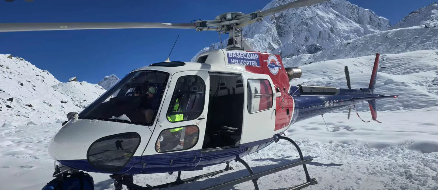A Base Camp helicopter landing on a snowy terrain at Gorakshep during the Luxury Everest Base Camp Trek with Helicopter Return, with dramatic snow-covered Himalayan mountains rising under a clear blue sky in Nepal’s Everest region.