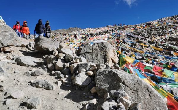 Pilgrims walking along a rocky trail near Mount Kailash, during Mount Kailash Mansarovar Tour via Hilsa