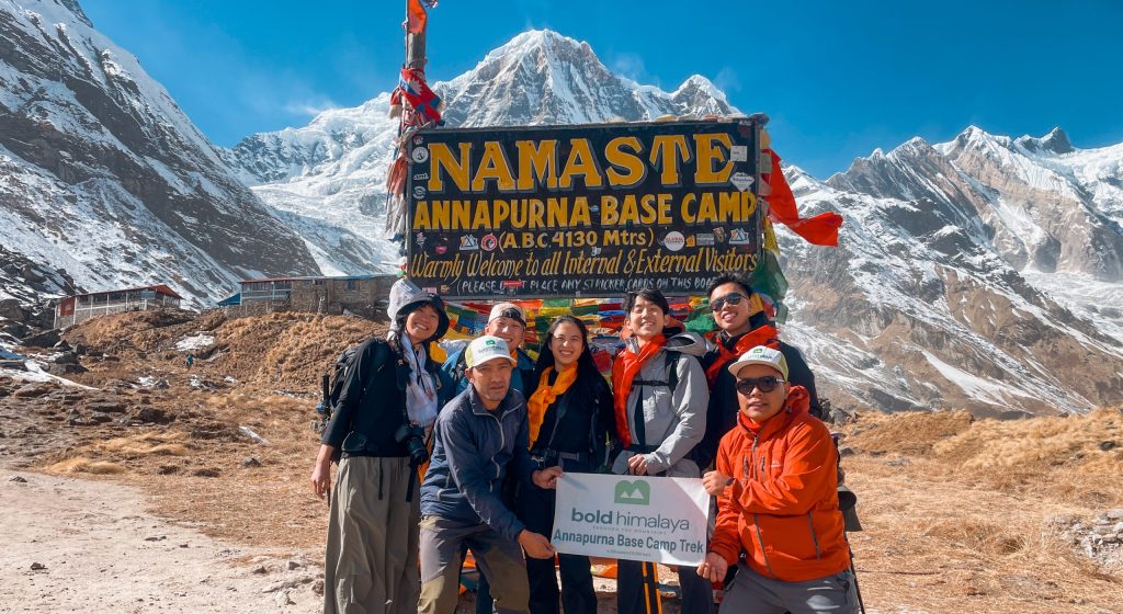 Trekkers celebrating at Annapurna Base Camp, representing one of the best treks in Nepal for 2026