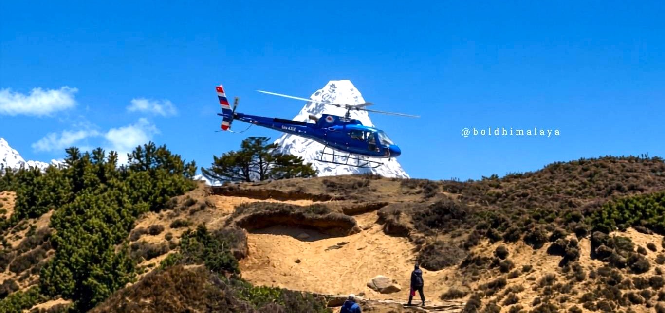 Helicopter descending to land with Ama Dablam mountain visible in the background, one of the most luxurious things to do in Nepal.