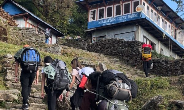 Trekkers carrying trekking bags along the Ghorepani trek, a popular route admired for its natural beauty and part of many luxury trekking in Nepal