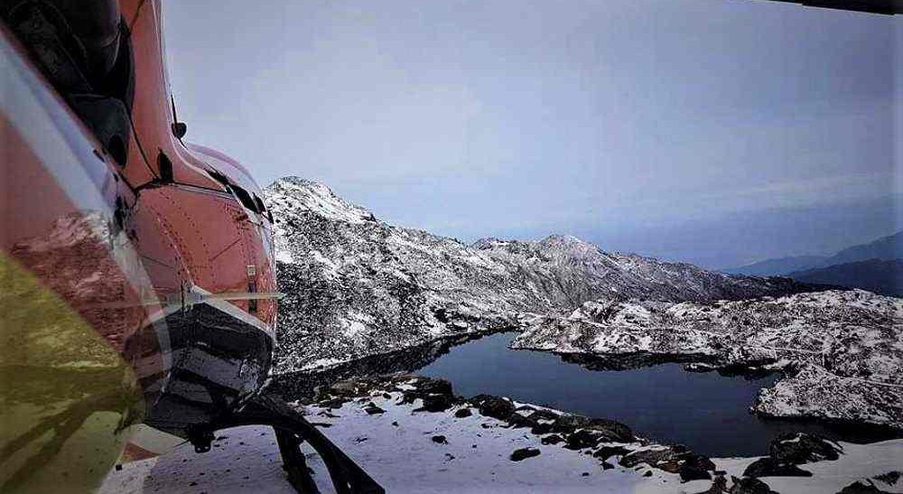 Aerial view of Gosaikunda Lake and surrounding snow-covered mountains taken from a helicopter ride in Nepal