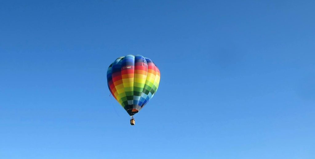 Hot air balloon flying in the clear sky, one of the best experiences to do in Nepal