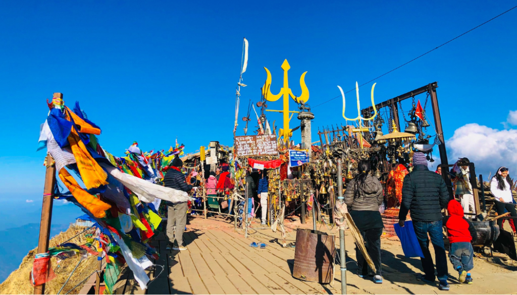 Kalinchowk Bhagwati Temple on a sunny day with clear blue skies, devotees visiting the sacred shrine in Dolakha, Nepal-Helicopter Tours from Kathmandu