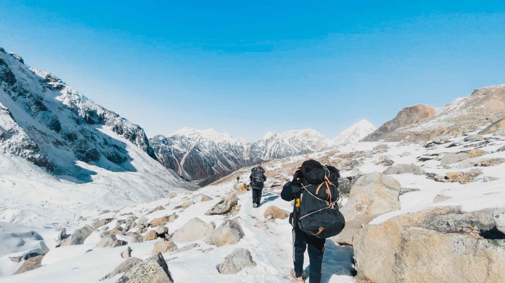 Trekkers making their way through the snowy high-altitude trails of the Manaslu Circuit, one of the best treks in Nepal known for its pristine landscapes and remote Himalayan beauty.