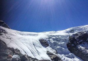 Snow-covered slopes and glaciers beneath the bright blue sky at Mera Peak.