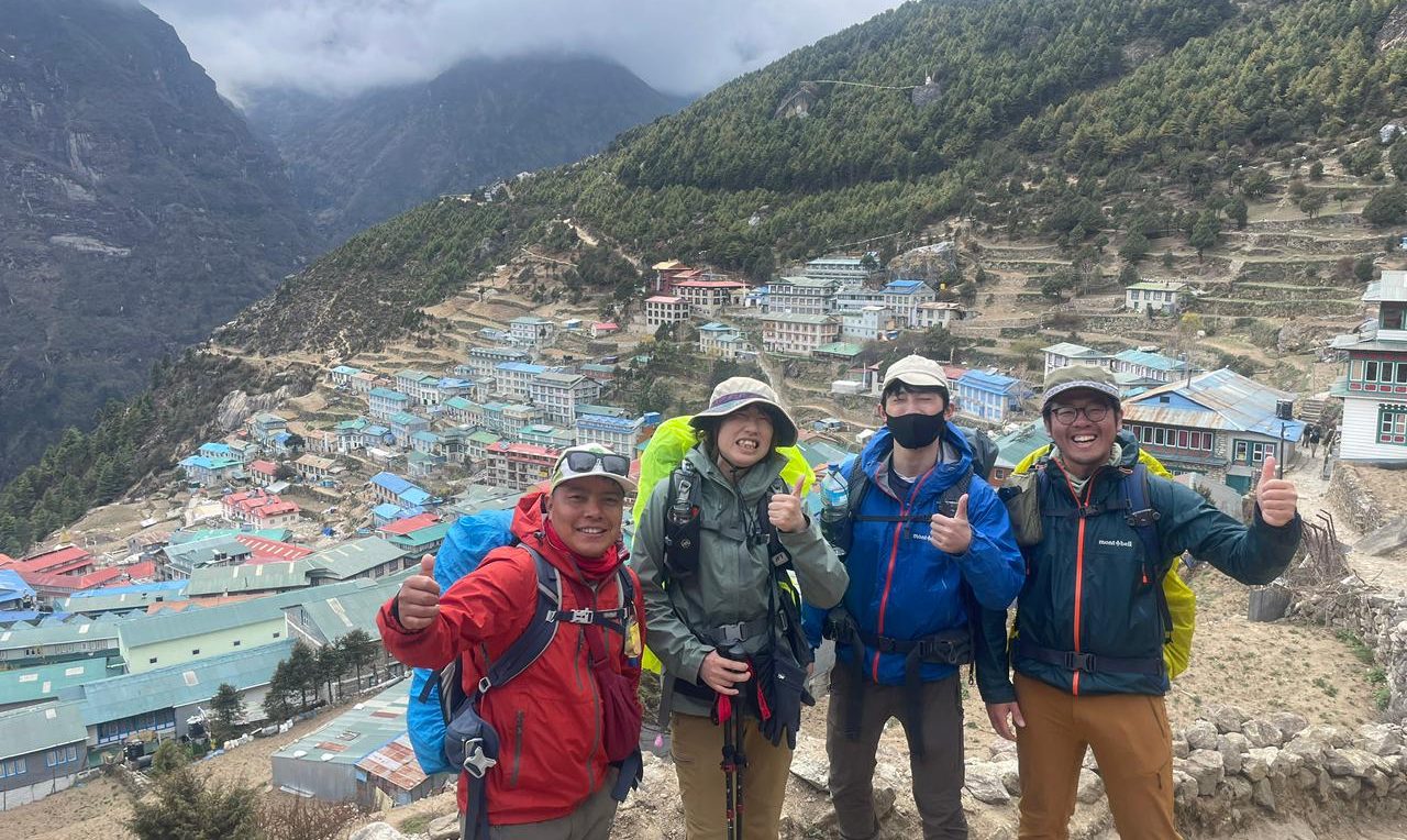 Hiring a trekking guide in Nepal helps trekkers capture photos during a Himalayan trek