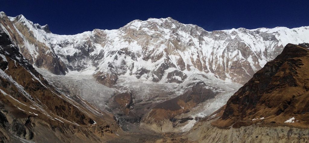 Snow-covered peaks of the Annapurna mountain range under a clear blue sky