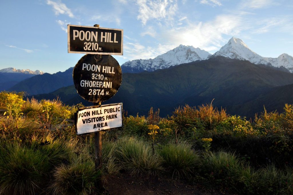 Sunrise view from Poon Hill with signpost and Annapurna mountains during the Ghorepani Poonhill Trek 3 Days.-best treks in nepal