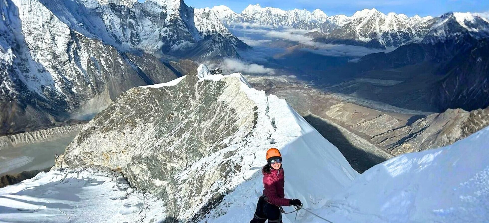 Climber at the snowy ridge of Island Peak (Imja Tse) with dramatic Himalayan mountains in the background, one of the easy peaks to climb in Nepal