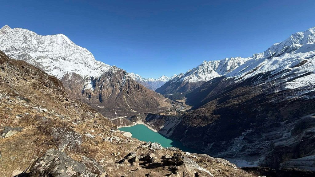 Rupina La Pass Trek, Manaslu, Nepal showing trekkers on a high mountain pass surrounded by snow-capped peaks and pristine alpine landscapes.