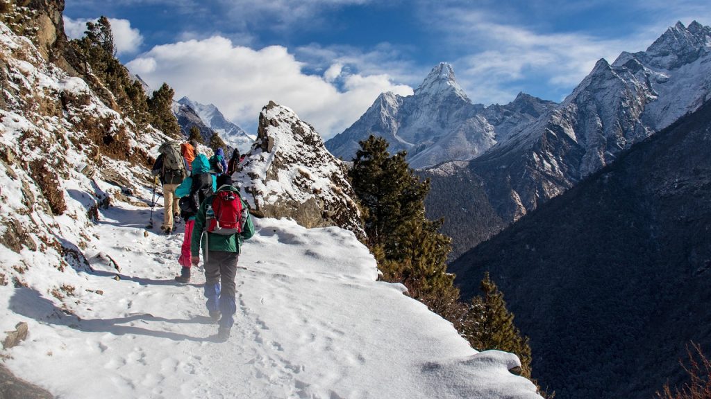 Trekking vs hiking comparison showing a multi-day mountain trek with a backpacker and a short day hike