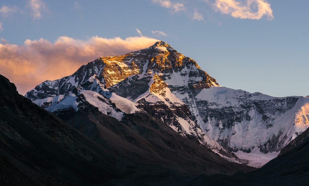 mount everest peak glowing at sunrise in the himalayas with snow covered ridges