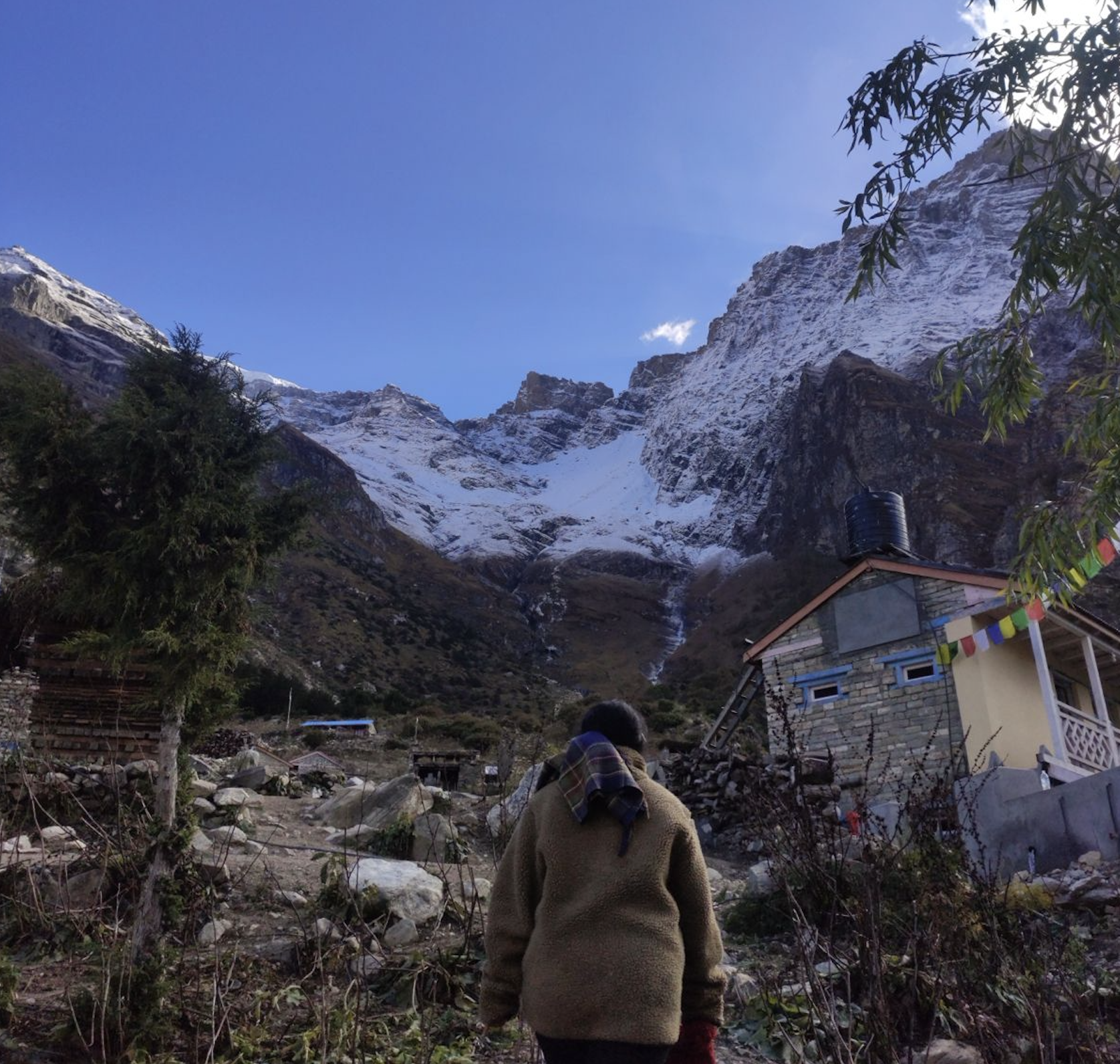 Meta Village with colorful prayer flags and traditional villages against Himalayan mountain backdrop during the Nar Phu Valley Trek in Nepal