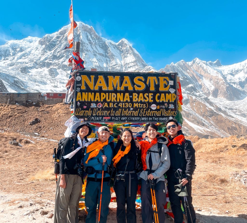 Trekkers posing for photo in Annapurna Base Camp, during monsoon treks in Nepal