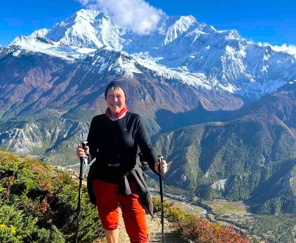 Trekker hiking the Annapurna Circuit surrounded by towering Himalayan peaks, one of the Monsoon treks in Nepal