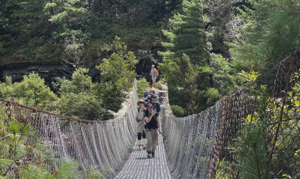 Trekkers crossing a suspension bridge en route to Upper Pisang on the Annapurna Circuit-Annapurna Circuit Trek vs Everest Base Camp Trek