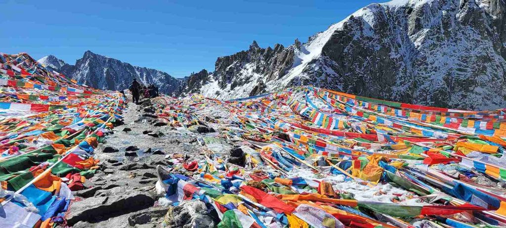 Dolma La Pass with prayer flags during Kailash Parikram-Helicopter vs Overland Kailash Mansarovar