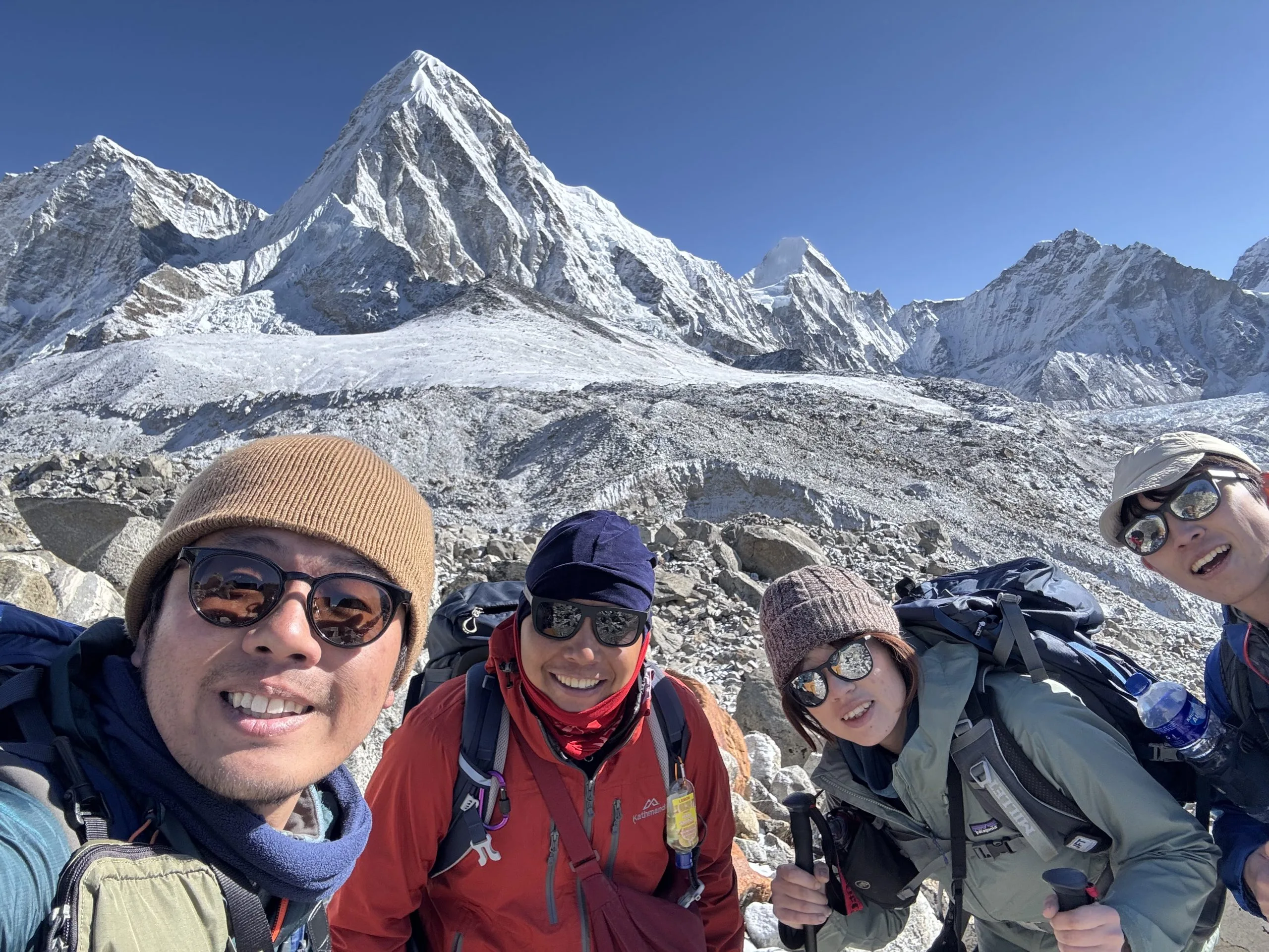 Happy trekker on the trail from Lobuche to Gorakshep with Mount Pumori in the background