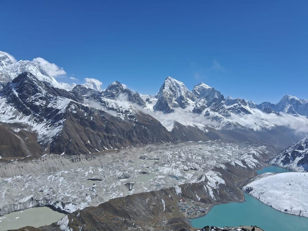 Panoramic view of Ngozumpa Glacier, Gokyo Lake, and surrounding Himalayan peaks seen from the top of Gokyo Ri