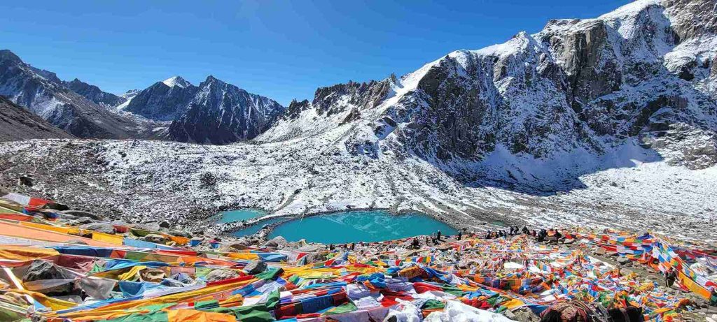 Devotees and prayer flags at Gauri Kund during Kailash Parikrama-Kailash Yatra