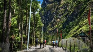 Trekkers walking along the scenic trail of the Annapurna Circuit trek with Tilicho Lake.