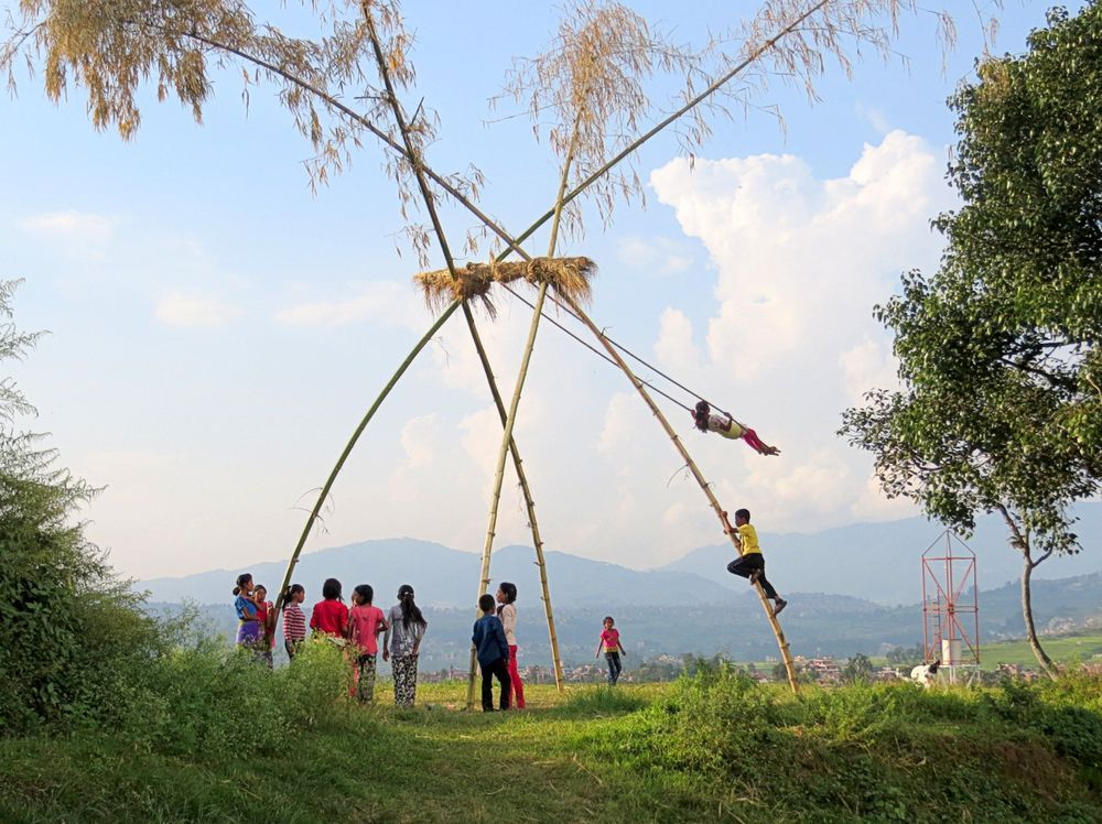 Dashain ping bamboo swing in Nepal with children playing