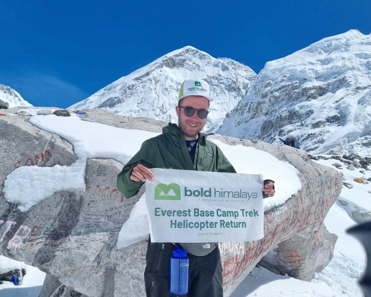 Trekkers at Everest Base Camp (5,364 m / 17,598 ft) enjoying the Himalayan scenery before helicopter return.