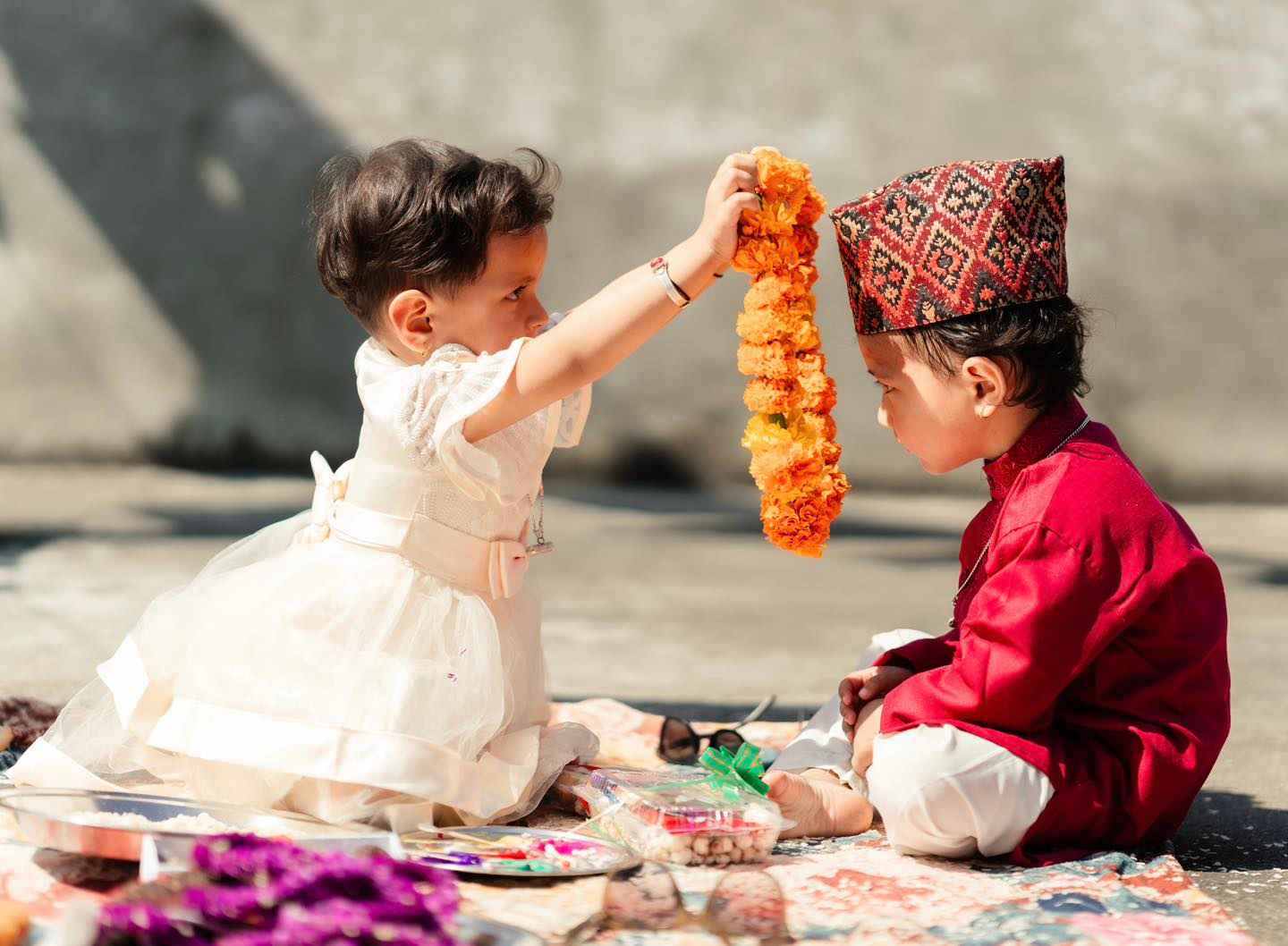 Sister applying tika and mala on brother’s forehead during Bhai Tika in Nepal.