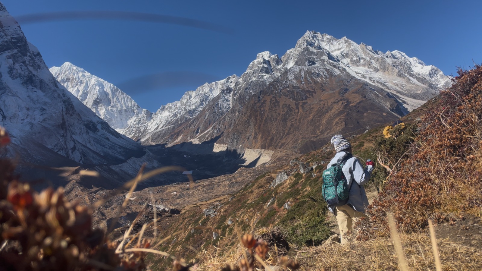 Trekkers passing through trails with snow-capped Himalayan peaks on the Manaslu Circuit Trek