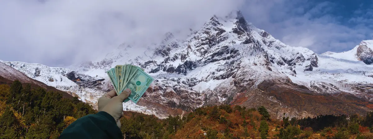 picture of cash holding in front of manaslu circuit trek