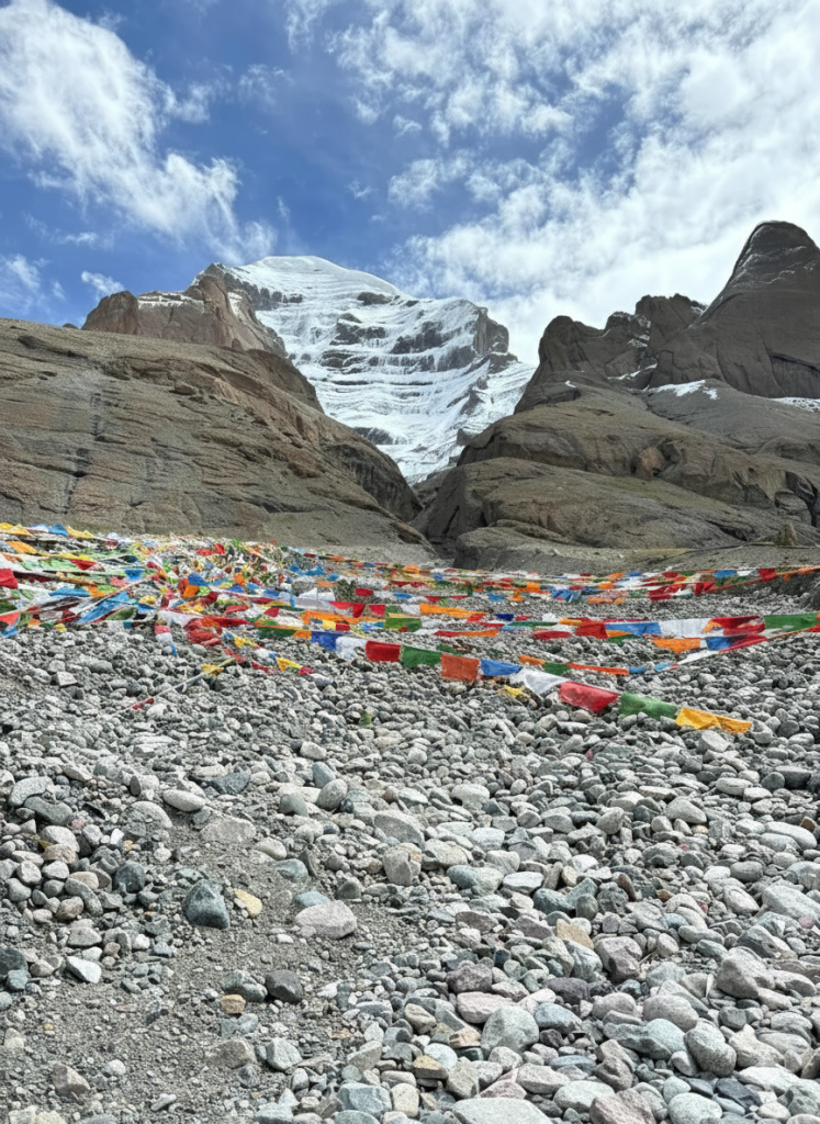 Prayer flags along the trekking route near Mount Kailash during the Kailash Mansarovar Yatra, reflecting terrain challenges and Kailash Mansarovar Yatra cost factors
