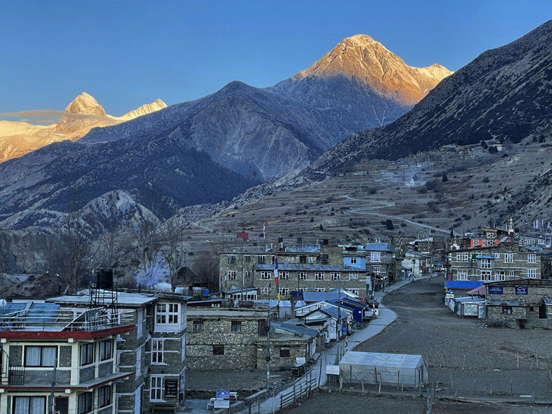 Morning view of Manang Village with snow-covered Himalayan peaks on the Annapurna Circuit during the Annapurna Base Camp Vs Annapurna Circuit Trek journey.