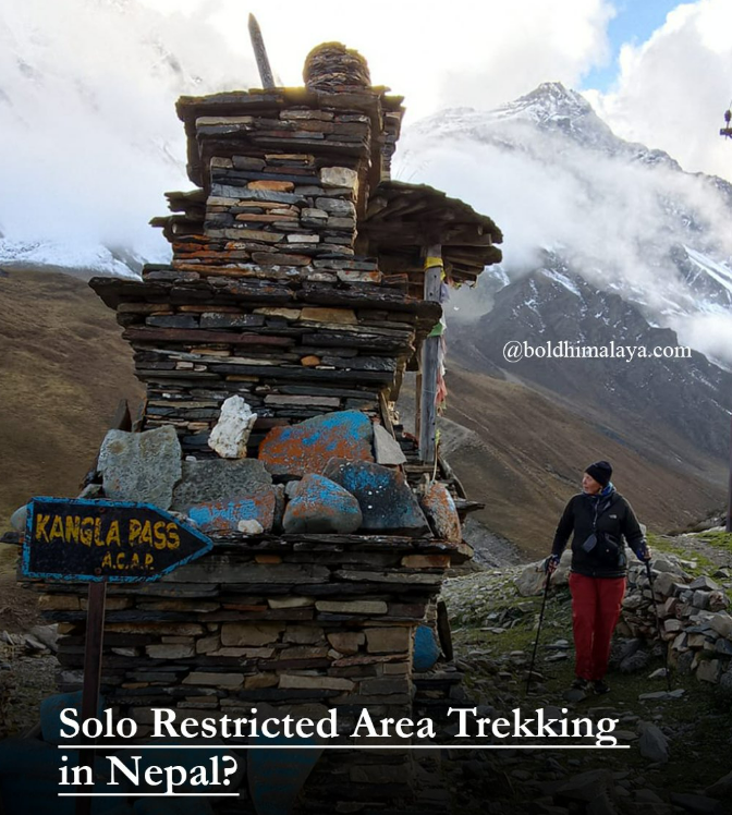 Solo trekking in Nepal at Kang La Pass with a lone hiker walking past a traditional stone chorten in the high Himalayas.