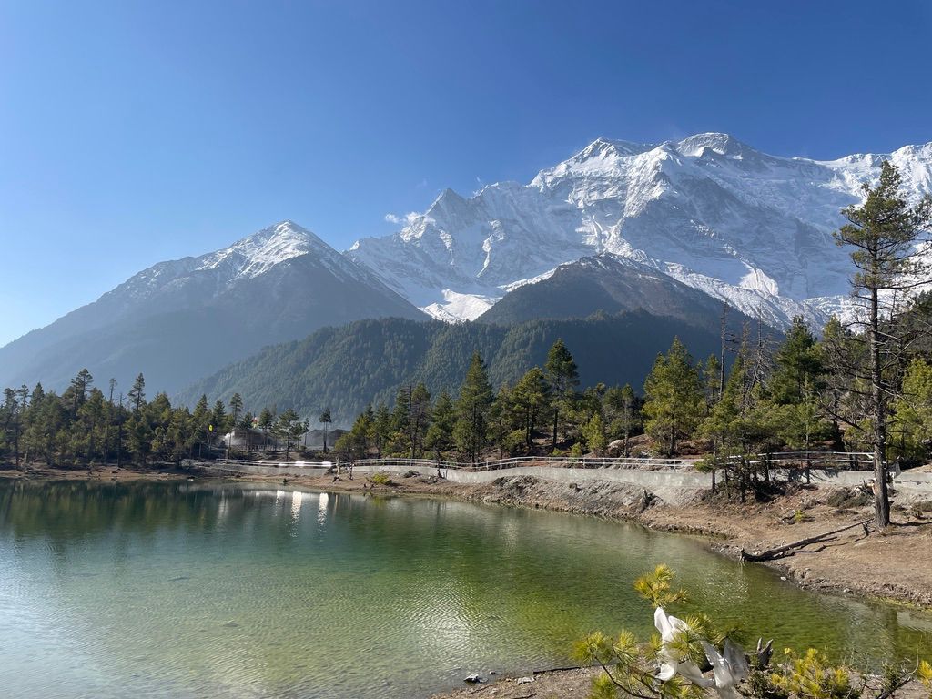 Green lake near Pisang in Manang during Manang Tour with Annapurna Himalaya reflections.