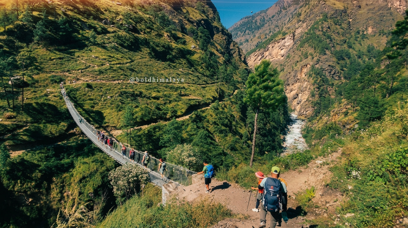 Trekkers crossing a suspension bridge on the Manaslu Circuit Trek in monsoon